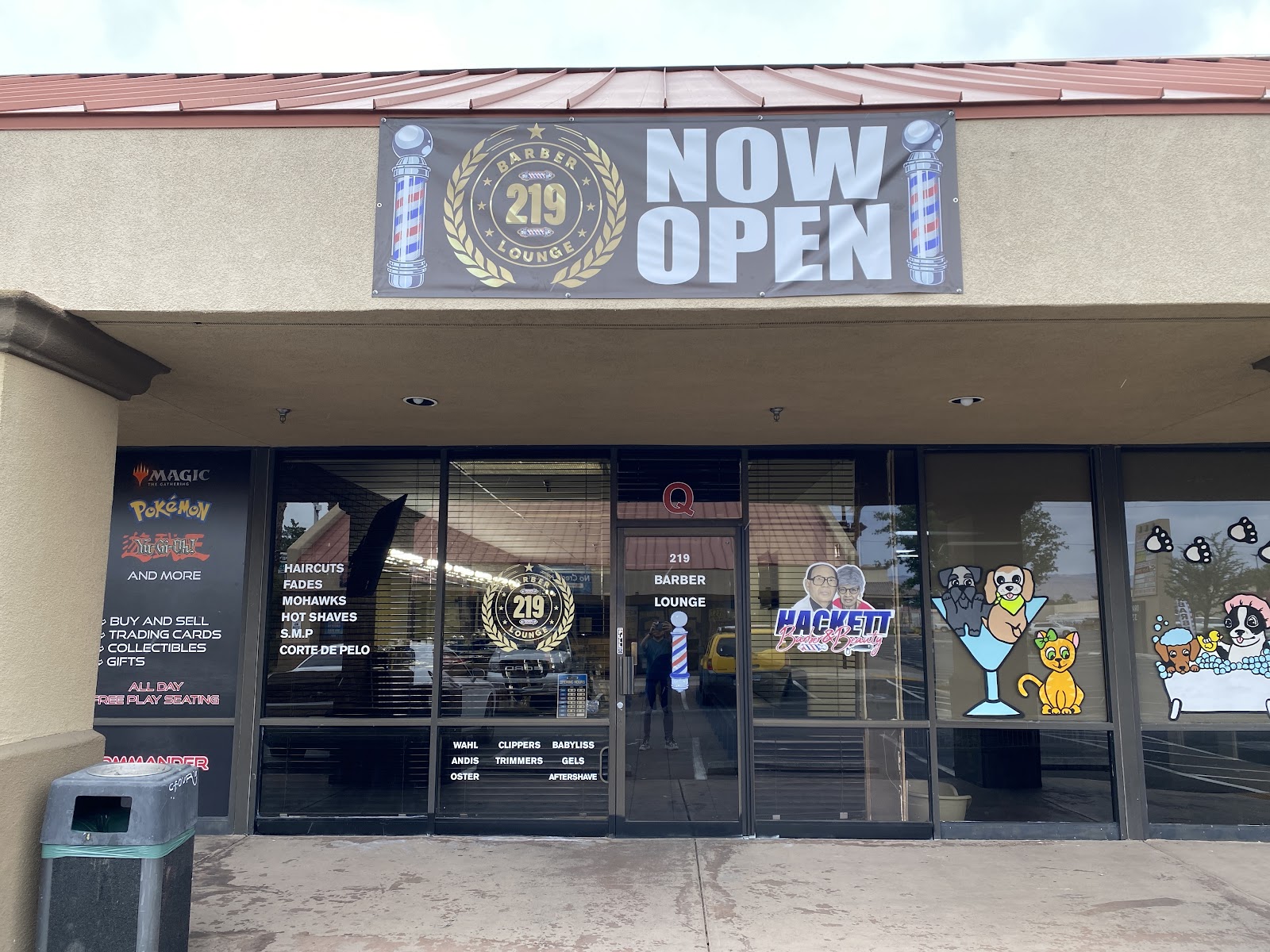 Exterior storefront with a 219 Barber Lounge NOW OPEN banner